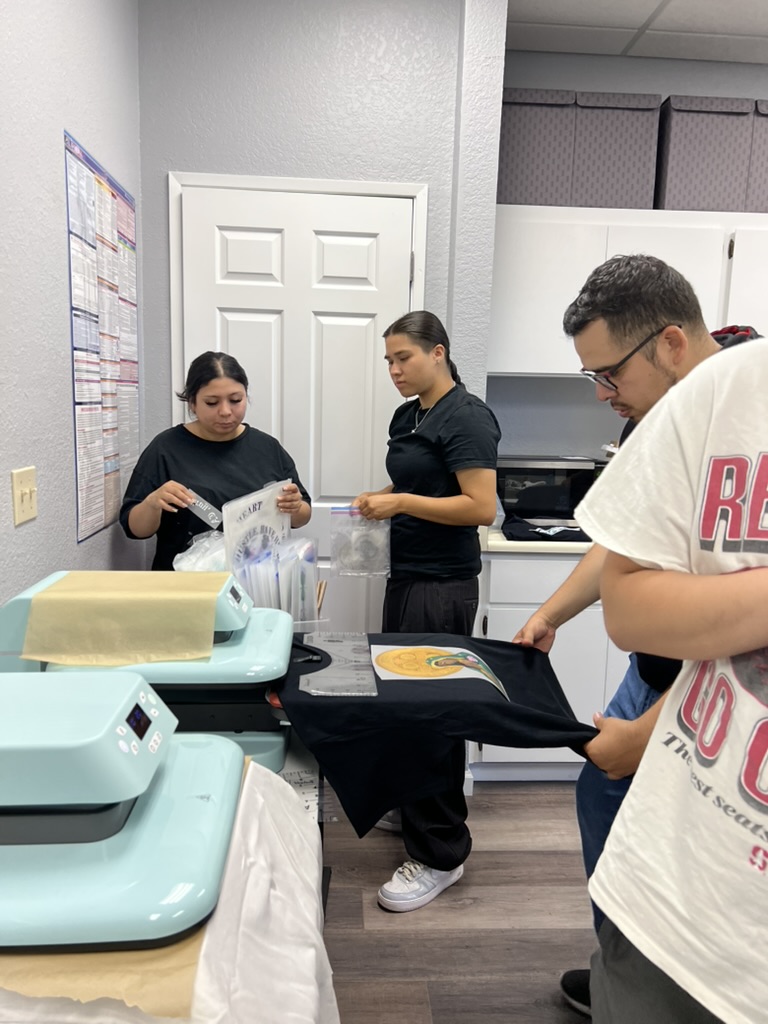 Young people producing apparel with EYPStudio heat presses